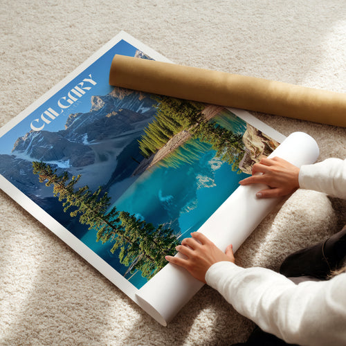 Person rolling up a Banff National Park poster showcasing Moraine Lake in the Canadian Rockies.